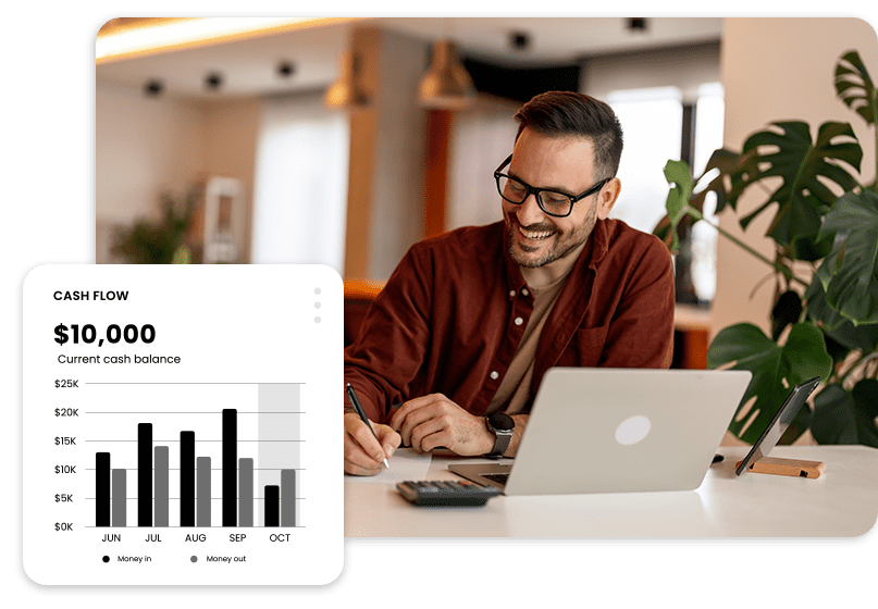 A man sits at a desk with a laptop and notepad, smiling. A graph shows cash flow trends with a current balance of $10,000.